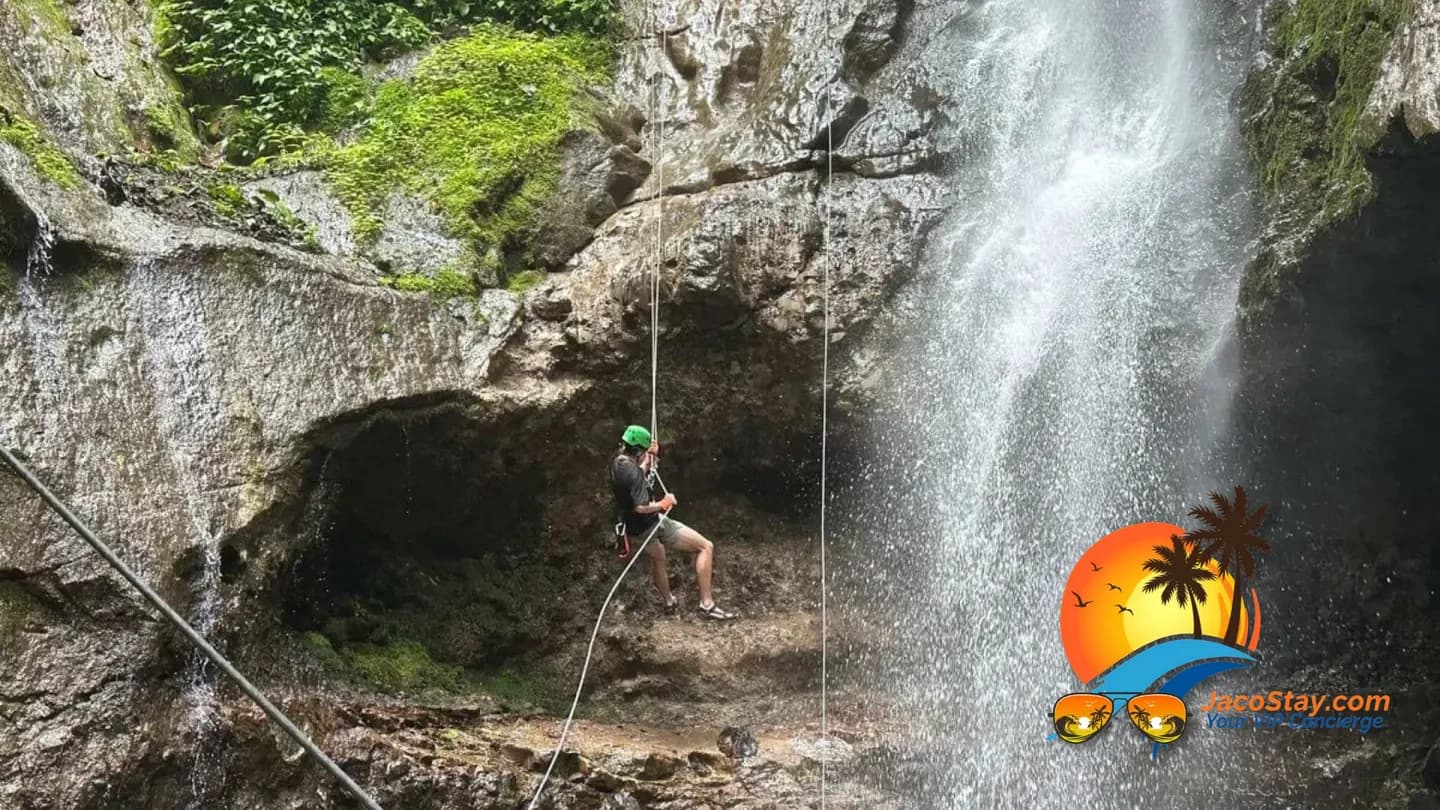 Couple exploring a tropical waterfall rappelling adventure in the Costa Rica rainforest