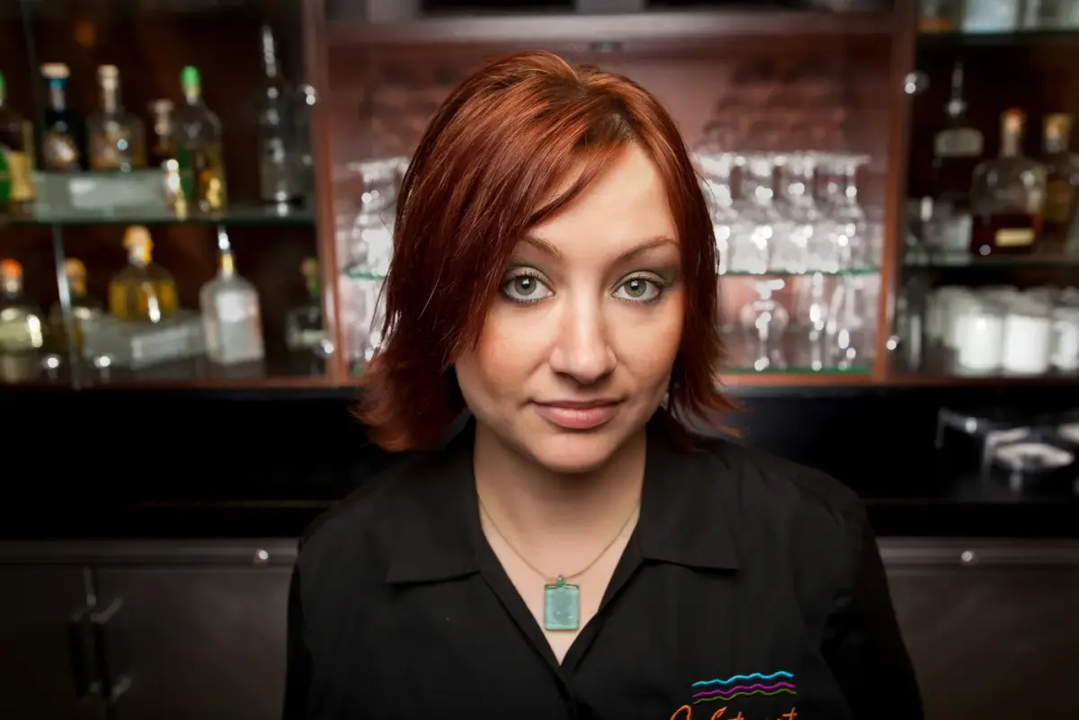 Professional restaurant hostess welcoming guests in Jaco Beach Costa Rica