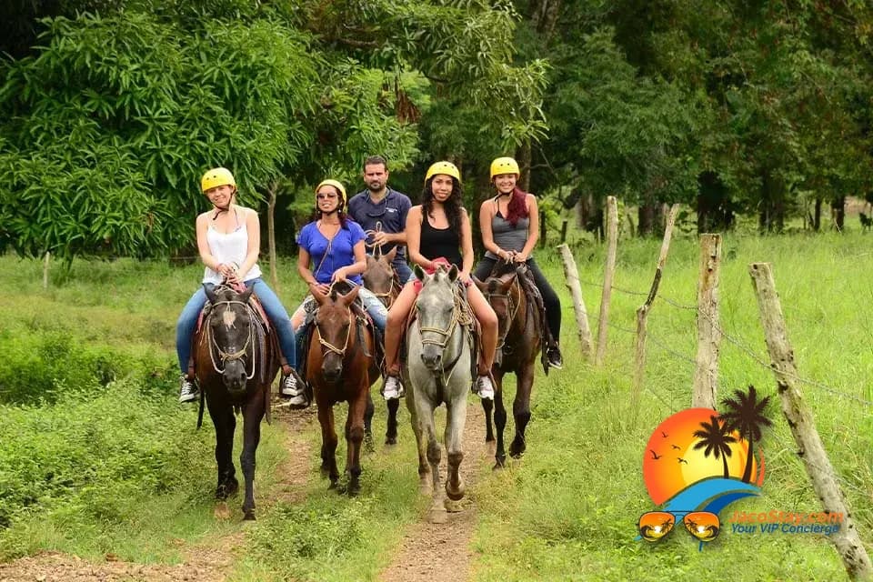 Couple horseback riding along Jaco Beach at sunset, Costa Rica