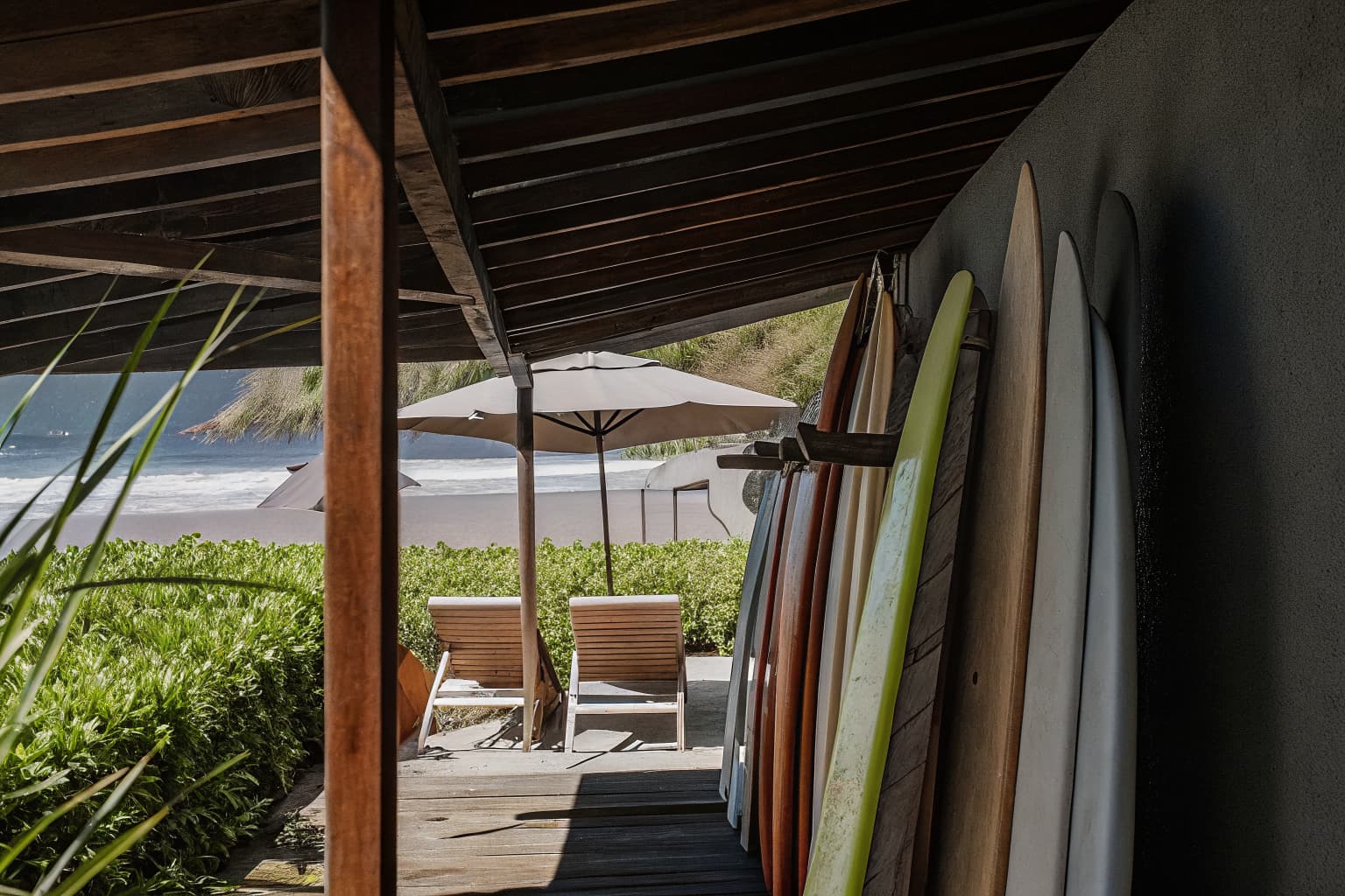 Surfboards and beach chairs ready for jaco family vacation activities at Jaco Beach Costa Rica