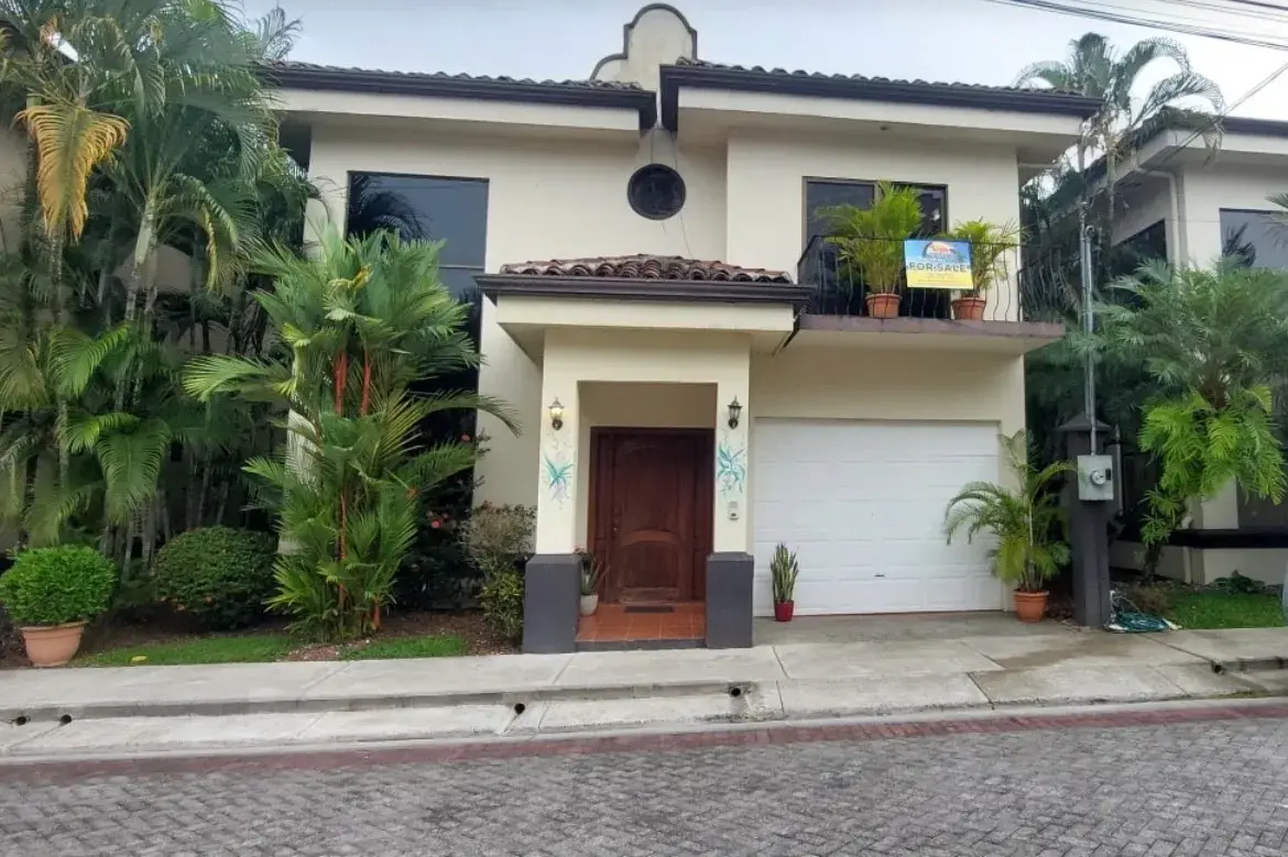 La Flor modern tropical beachfront home with lush palm landscaping in Jaco Beach